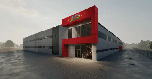 Edificio residencial moderno de varias plantas con diseño minimalista, grandes ventanales y formas geométricas, rodeado de vegetación y una zona de aparcamiento bajo un cielo nublado.