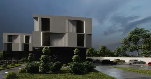 Edificio residencial moderno de varias plantas con diseño minimalista, grandes ventanales y formas geométricas, rodeado de vegetación y un aparcamiento bajo un cielo nublado.
