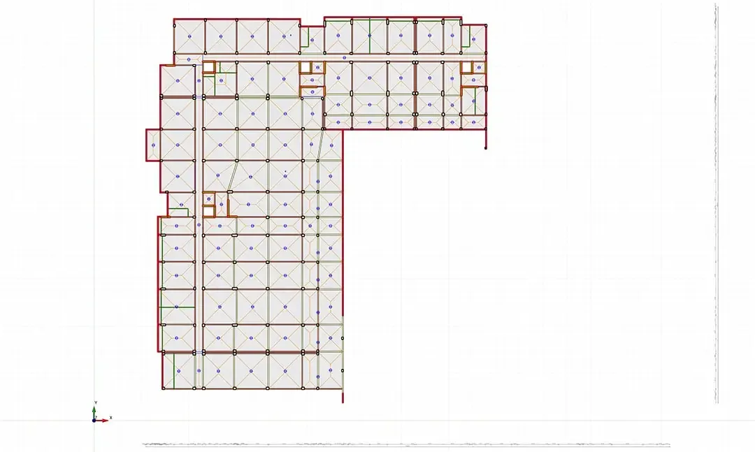 Plan de structure d'un complexe résidentiel à emprise en L avec l'implantation des panneaux de dalle